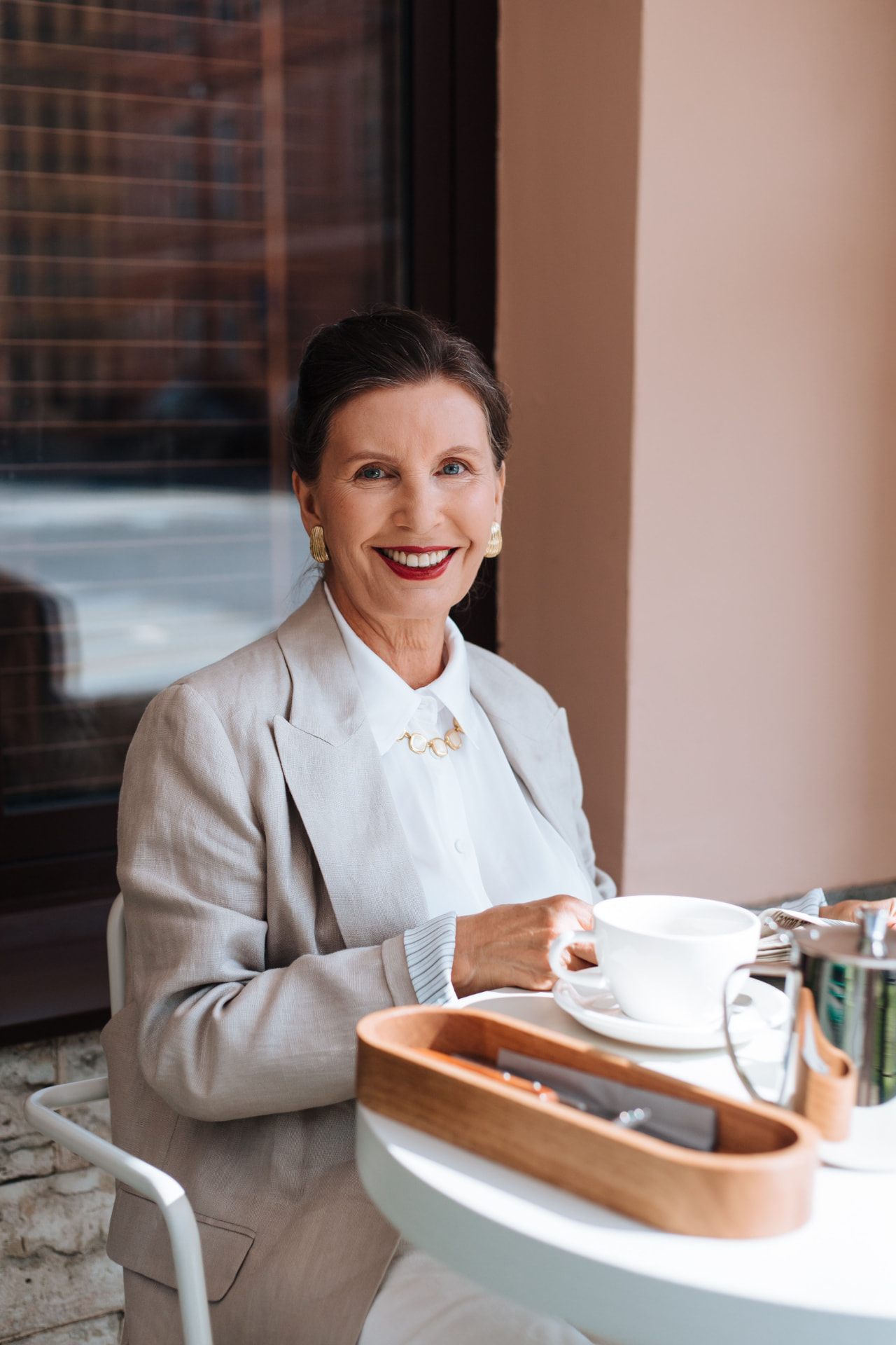 Smiling woman enjoying coffee at a café