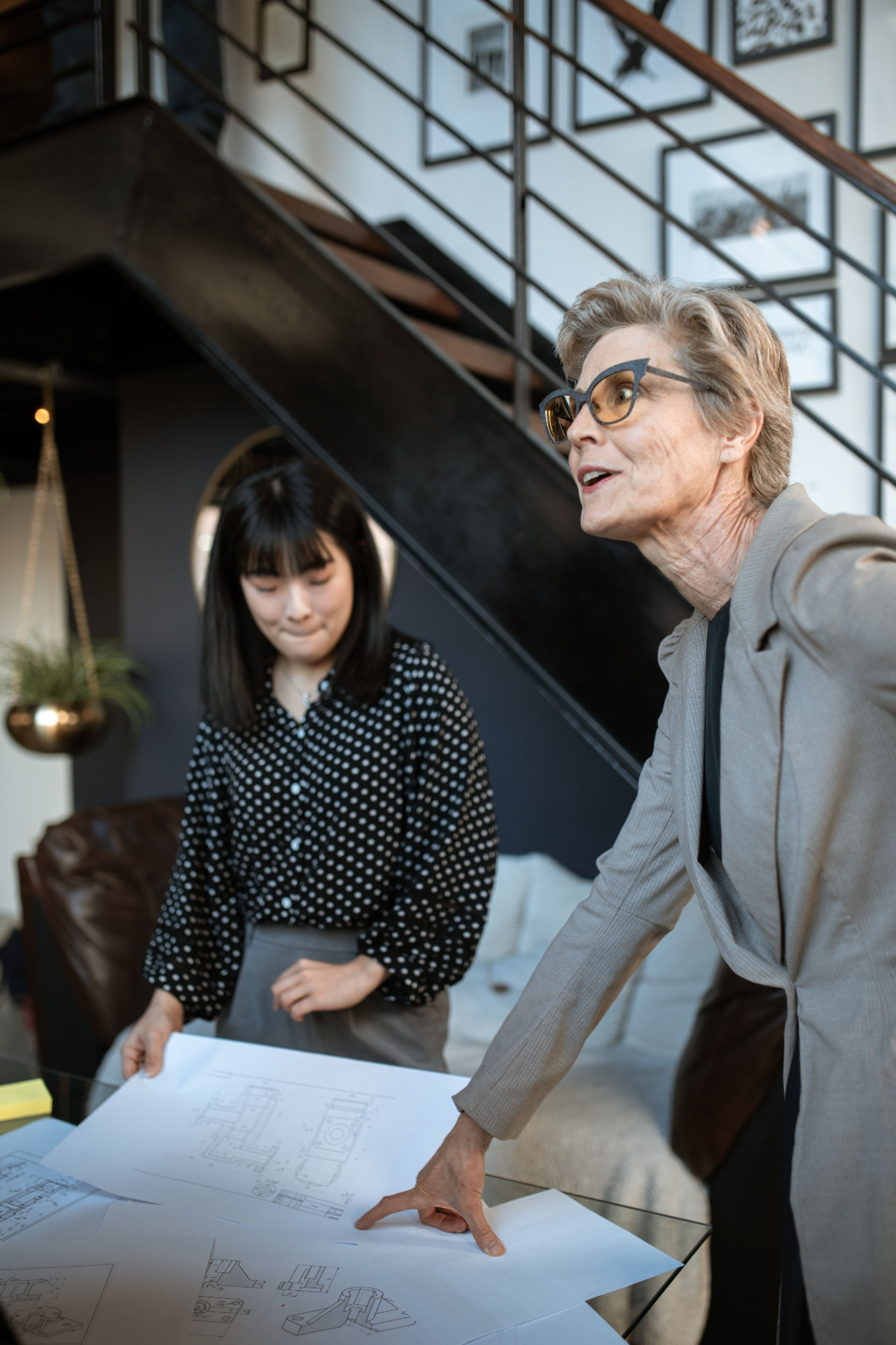 Two women reviewing architectural plans together